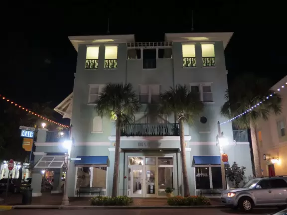 A popular town center with sidewalk cafes leading down to a pretty lake with a walking path.