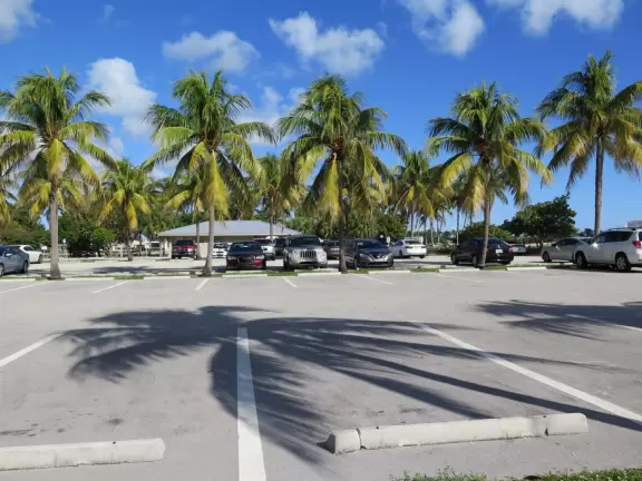 Large lagoon with clear water where kids can swim, tons of shade, and playground in the sand.
