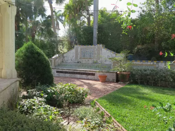 It's blissful to walk past hibiscus flowers, bougainvillea, coconut trees, tall hedges, and mansions, down to the sea.