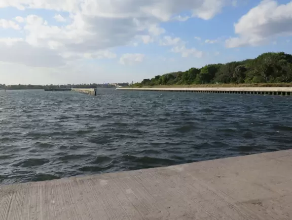 Nice place to park and watch the water rushing in, or stand on the cement jetty and look back at the beach.