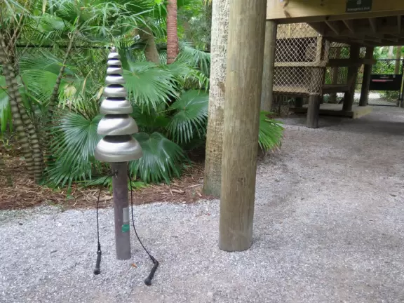 Lush paradise with water lilies galore, rustling bamboo, stone bridge, tropical flowers, strangler fig, and a gorgeous royal palm grove.