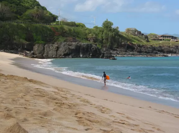 April morning at Waimea Bay. See the huge rock in the distance, where people jump hazardously off into the water.