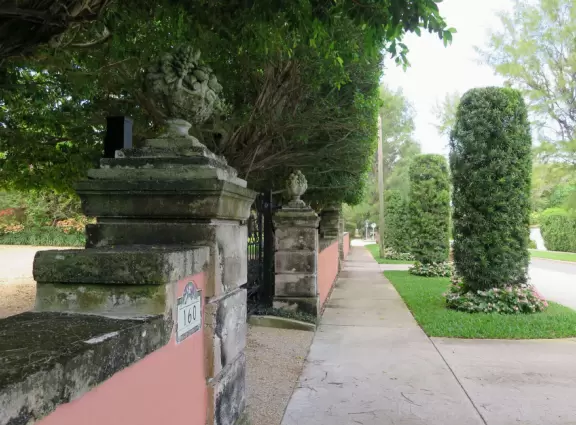 Walk past mansions in the shade of pine and palm trees on Palm Beach Island.