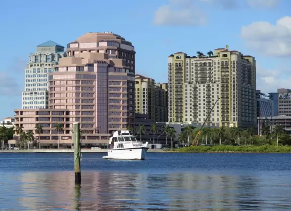 A cement bike and walking path along the intercoastal waterway in front of mansions and past glorious trees.