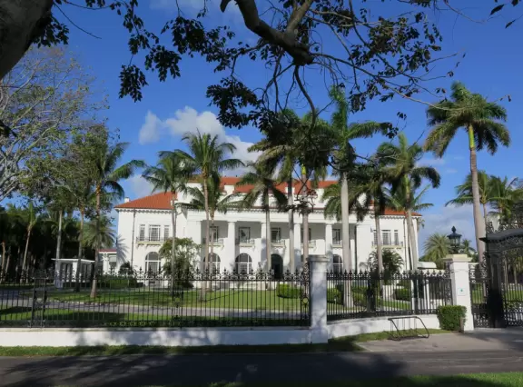 A cement bike and walking path along the intercoastal waterway in front of mansions and past glorious trees.