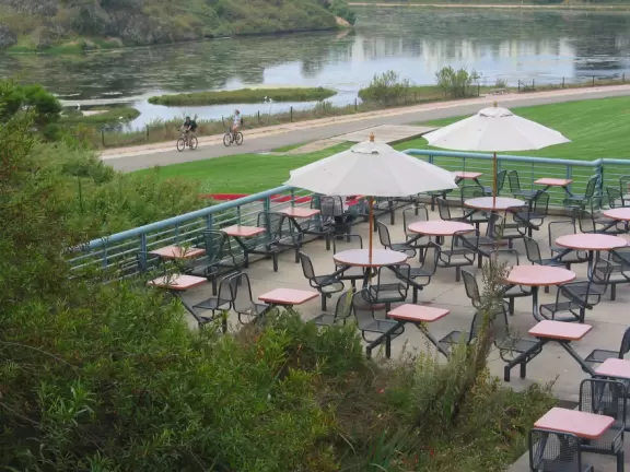 A walk past grassy knolls, a shimmering lagoon, and picturesque bluffs above the ocean, all in the vibrant atmosphere of campus!