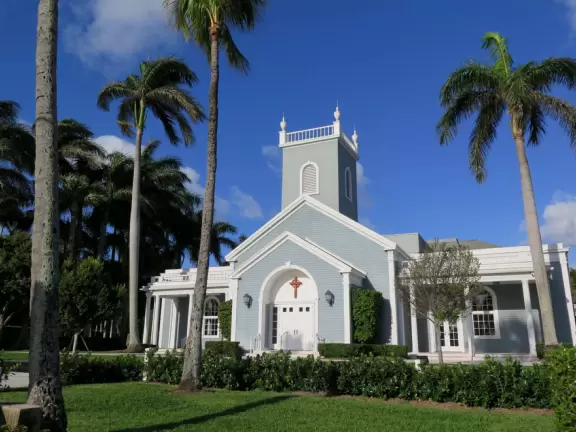 A cement bike and walking path along the intercoastal waterway in front of mansions and past glorious trees.
