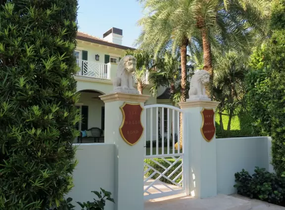 Walk past mansions in the shade of pine and palm trees on Palm Beach Island.
