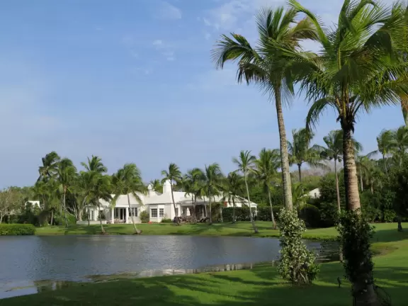Stroll along a pedestrian-only street beside the blissful intracoastal waterway beside mansions with lush gardens under swishing coconut trees.