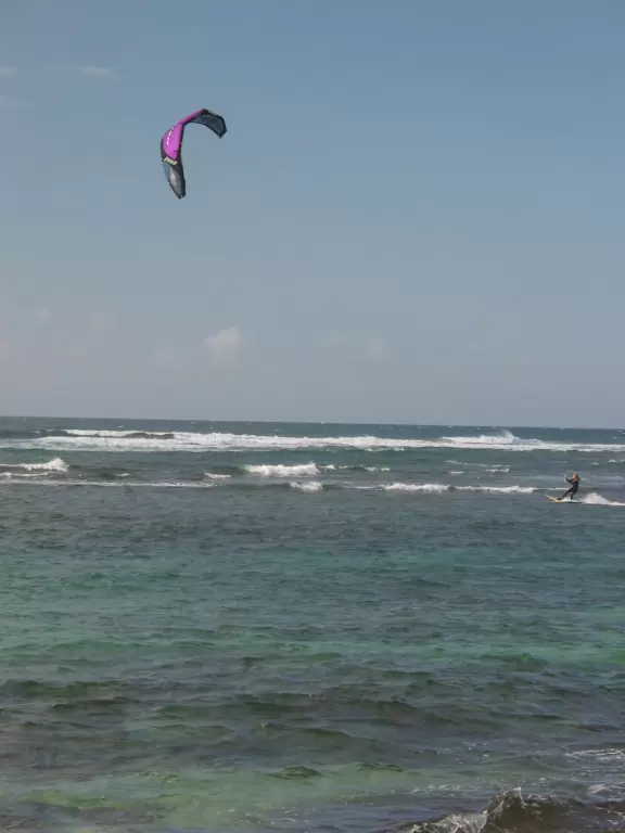 Incredible high mountains rise above this pretty beach.