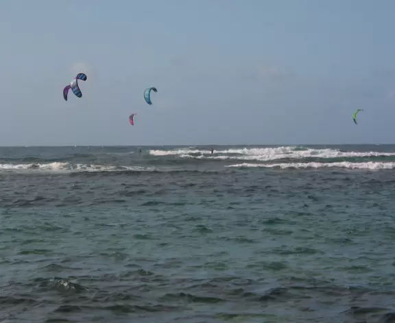 Incredible high mountains rise above this pretty beach.