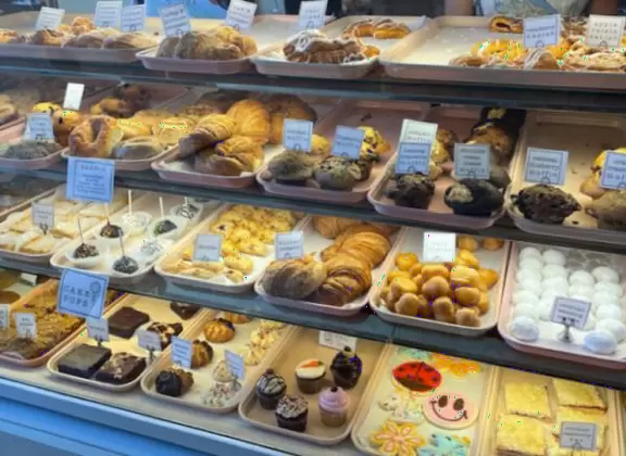Sit here on a red brick terrace in the sun and look out on the colored umbrellas and bell tower.