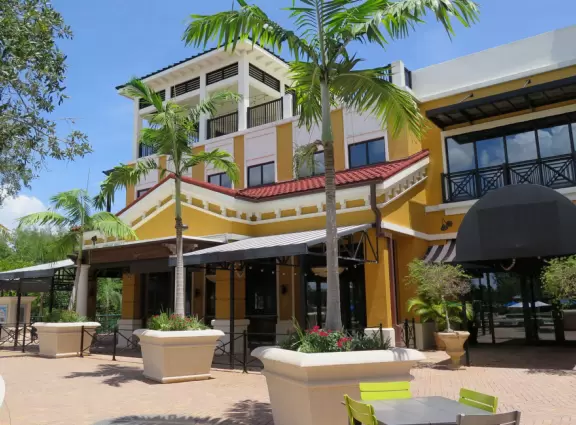 A happening spot with a sunken amphitheater by the water where kids can run in a splash pad and fountains are lit up at night.&nbsp; BurgerFi, Subculture Coffee, and a few restaurants.