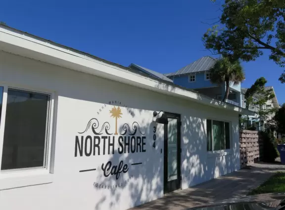 Cute street with white sand along the sidewalks. Little shops and cafes. White sand beach on one end and intracoastal pier on the other!