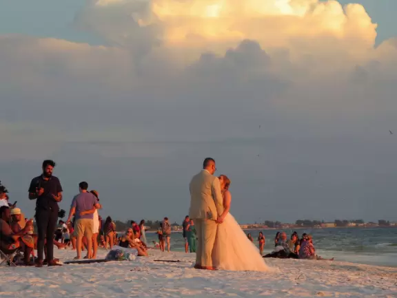 White sand beach with glorious sunsets. You can grab food at the cafes on Pine Ave and have a picnic at the beach.