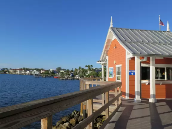 Pier with views of coastline, and older touristy street leading off it.