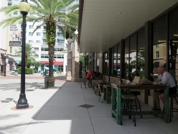 Shady street with many cafes.