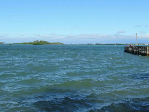 Waterfront park with amazing colors in the water- views of an island and blue-green sandbars. Plenty of benches and docks, and a playground.