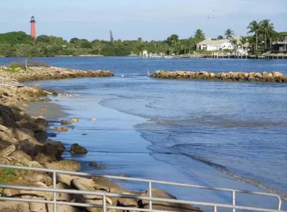 Large lagoon with clear water where kids can swim, tons of shade, and playground in the sand.