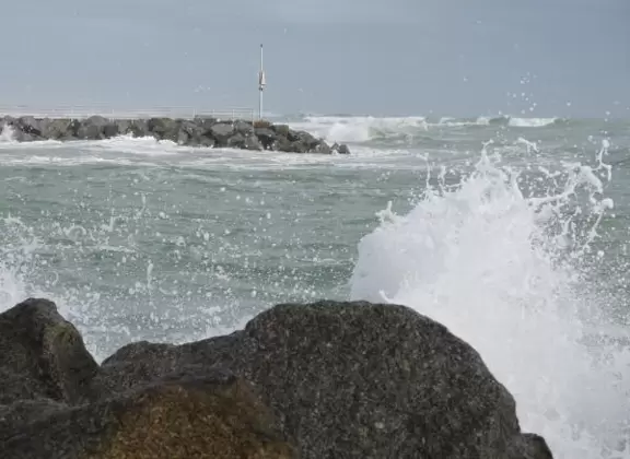 Beach where fishermen hang out on the jetty and surfers come to ride the waves at Jupiter Inlet.