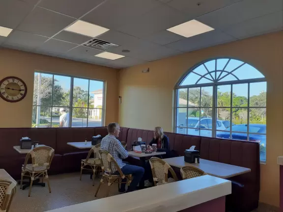 Long walk with wide sidewalk, past lush jungly forest. Some car noise.