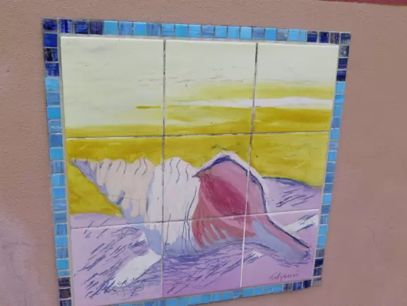 Shell tile mural on a wall.