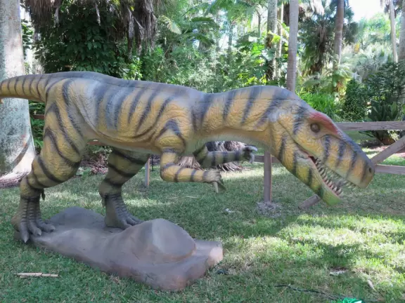 Lush paradise with water lilies galore, rustling bamboo, stone bridge, tropical flowers, strangler fig, and a gorgeous royal palm grove.