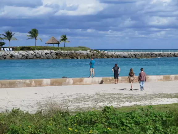 Beach where fishermen hang out on the jetty and surfers come to ride the waves at Jupiter Inlet.