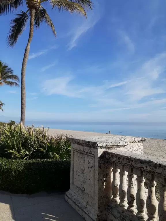 Incredible views of vibrant blue water, and a salmon pink wave wall with white trim.