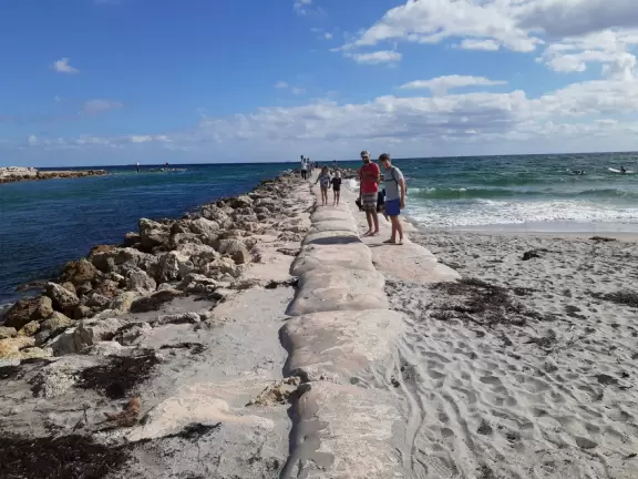 Pretty park, rock and sand bag jetty, and slightly grody beach on the inlet.