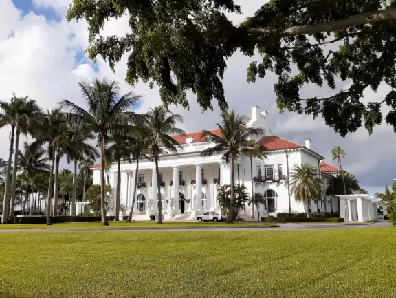 A cement bike and walking path along the intercoastal waterway in front of mansions and past glorious trees.