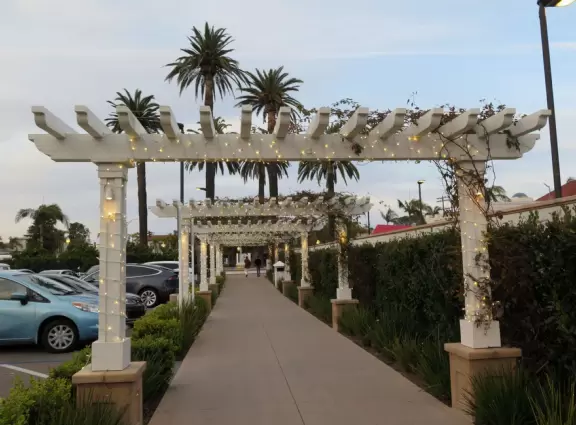 Historic resort with red turrets on foggy beach of fine white sand.