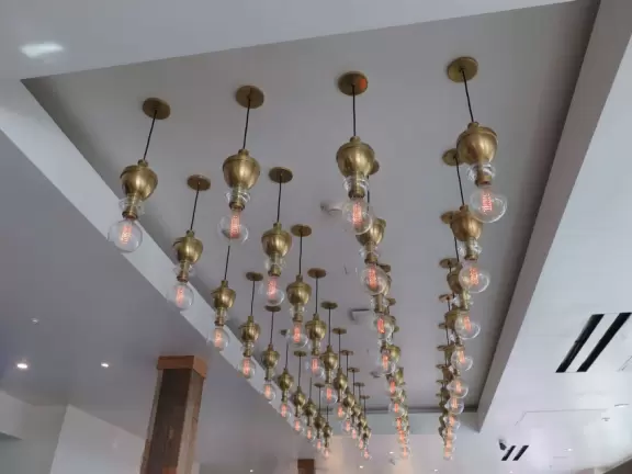 Historic resort with red turrets on foggy beach of fine white sand.