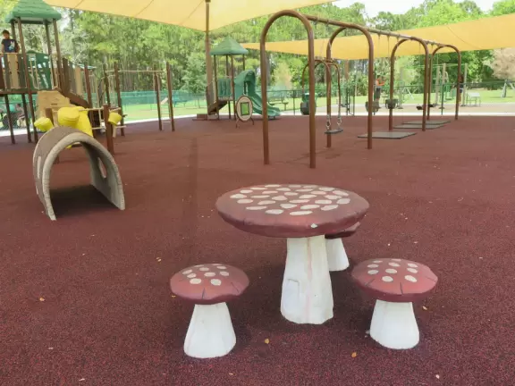 Fun park with playground and workout stations under huge shade canopy.
