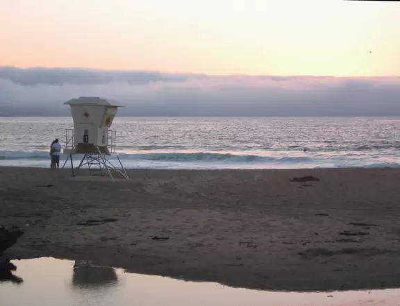 A wide stretch of beach with white sand, chilly winds, barking seals, and gorgeous sunsets.