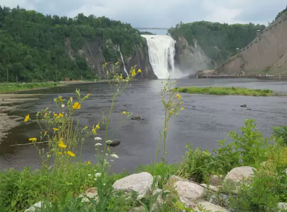 Tall waterfall at the mouth of the Montmorency River. You can walk stairs up to a suspension bridge over the falls.