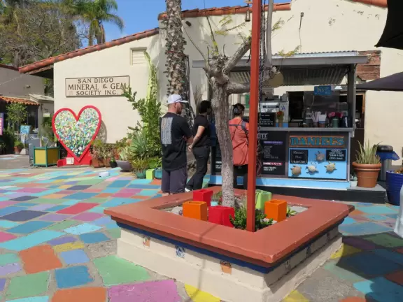 Special area of Balboa Park with adobe buildings, mesquite trees, and brightly colored tiles on the ground. Heart sculpture, and SD Gem Museum. Plus, the wonderful carousel!