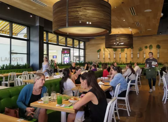 Indoor mall with sun canopies, decorative towers, fountains, and atriums.