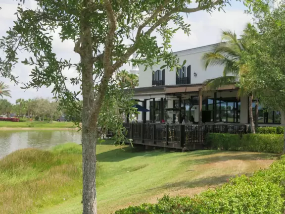 Town with splash pad on the lake, town square with cafes, playground, and lots of stores.