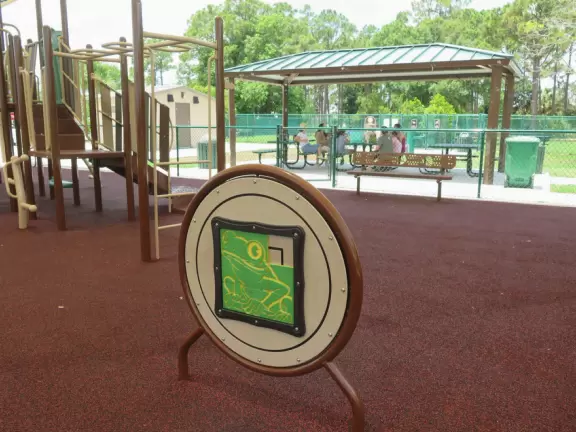 Fun park with playground and workout stations under huge shade canopy.