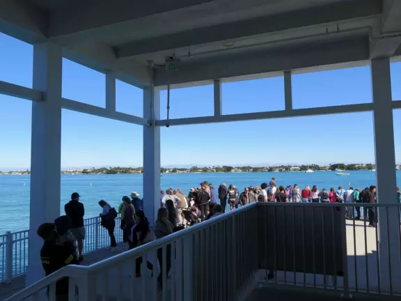 Two-level modern winter manatee viewing center with walkway by the water.