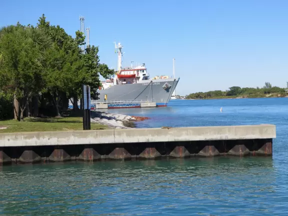 Two-level modern winter manatee viewing center with walkway by the water.