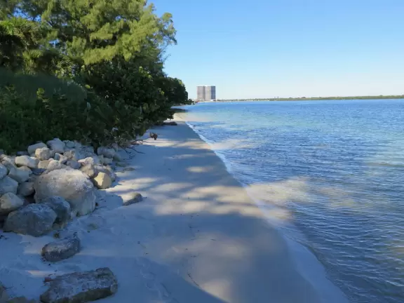 Gorgeous park with white sand beaches, ironwood trees, beach sunflowers, playground, basketball, and a pretty walkway.