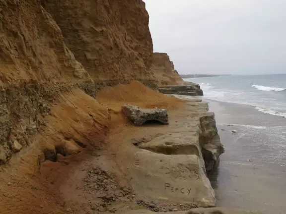 Gorgeous beach with steep steps leading down, and red cliffs like a national park!