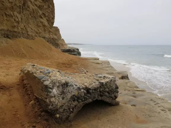 Gorgeous beach with steep steps leading down, and red cliffs like a national park!
