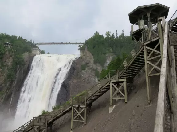 Tall waterfall at the mouth of the Montmorency River. You can walk stairs up to a suspension bridge over the falls.