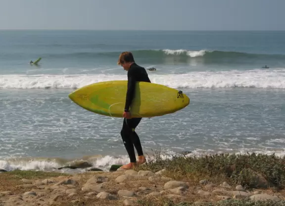 An amazing place to watch surfers ride the waves close up and in the shade, at that!