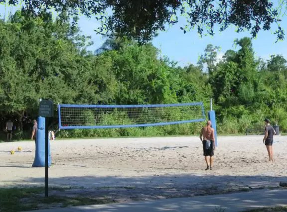 Huge space-age playground for big kids plus toddler playground and splash pad with view of the blue lake.