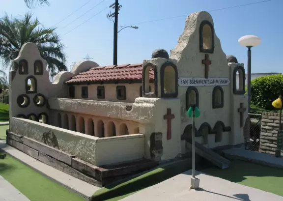 Mini-golf park with lush, colorful grounds, plus arcade games, mini-carousel, and rides.