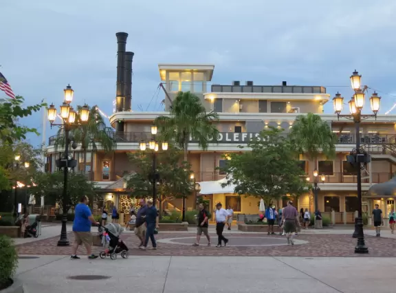 Waterfront area with restaurants, live street performers, entertainment, toy stores, and carousel.